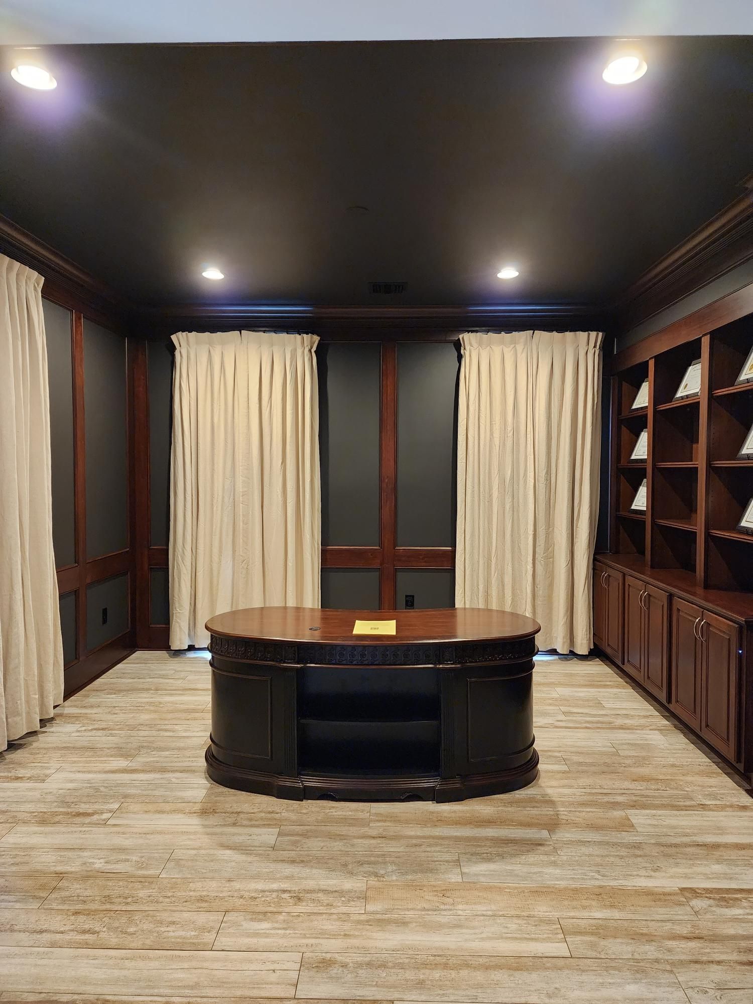 There is a large desk in the middle of the room.