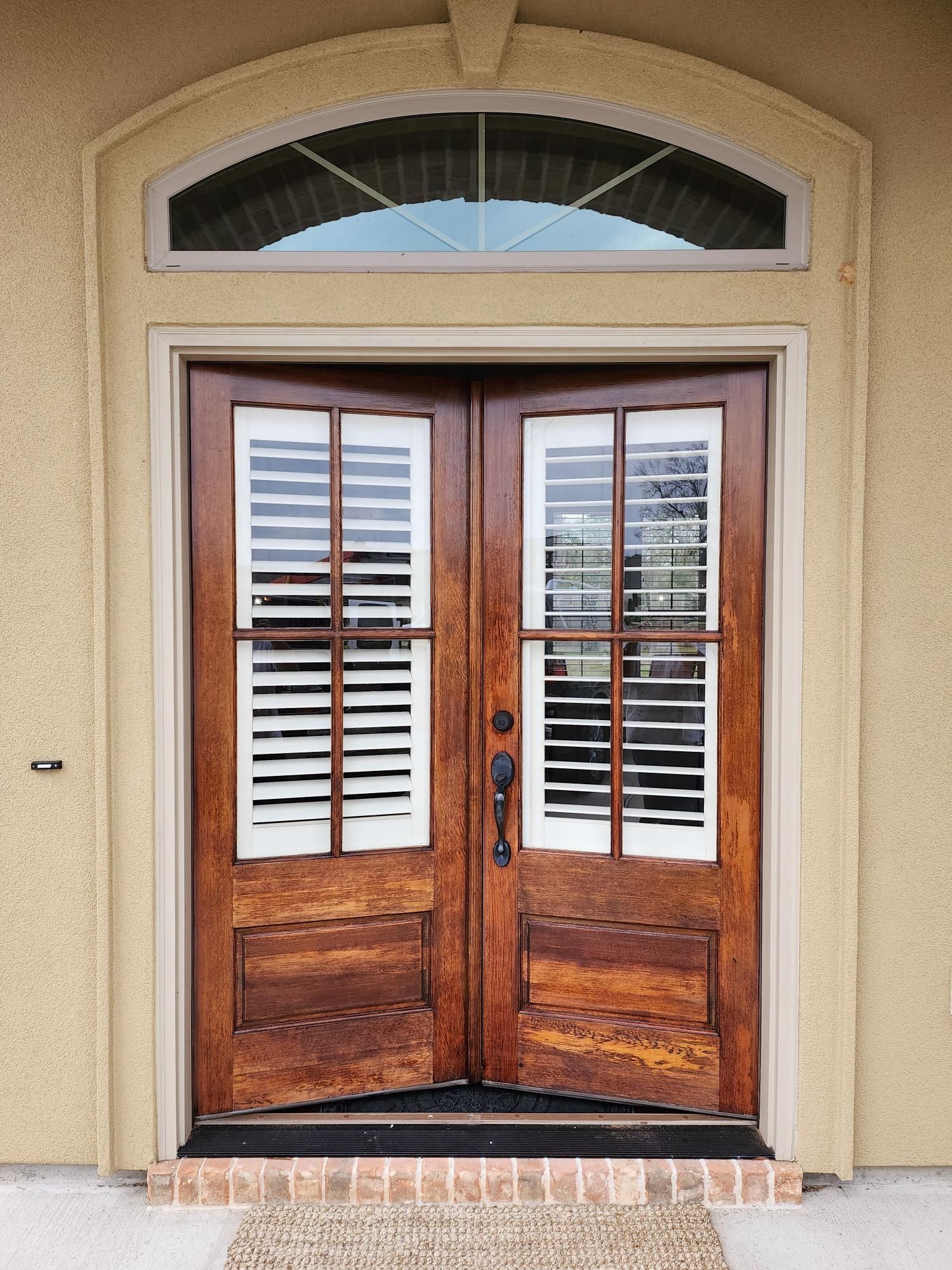 The front door of a house has shutters on it