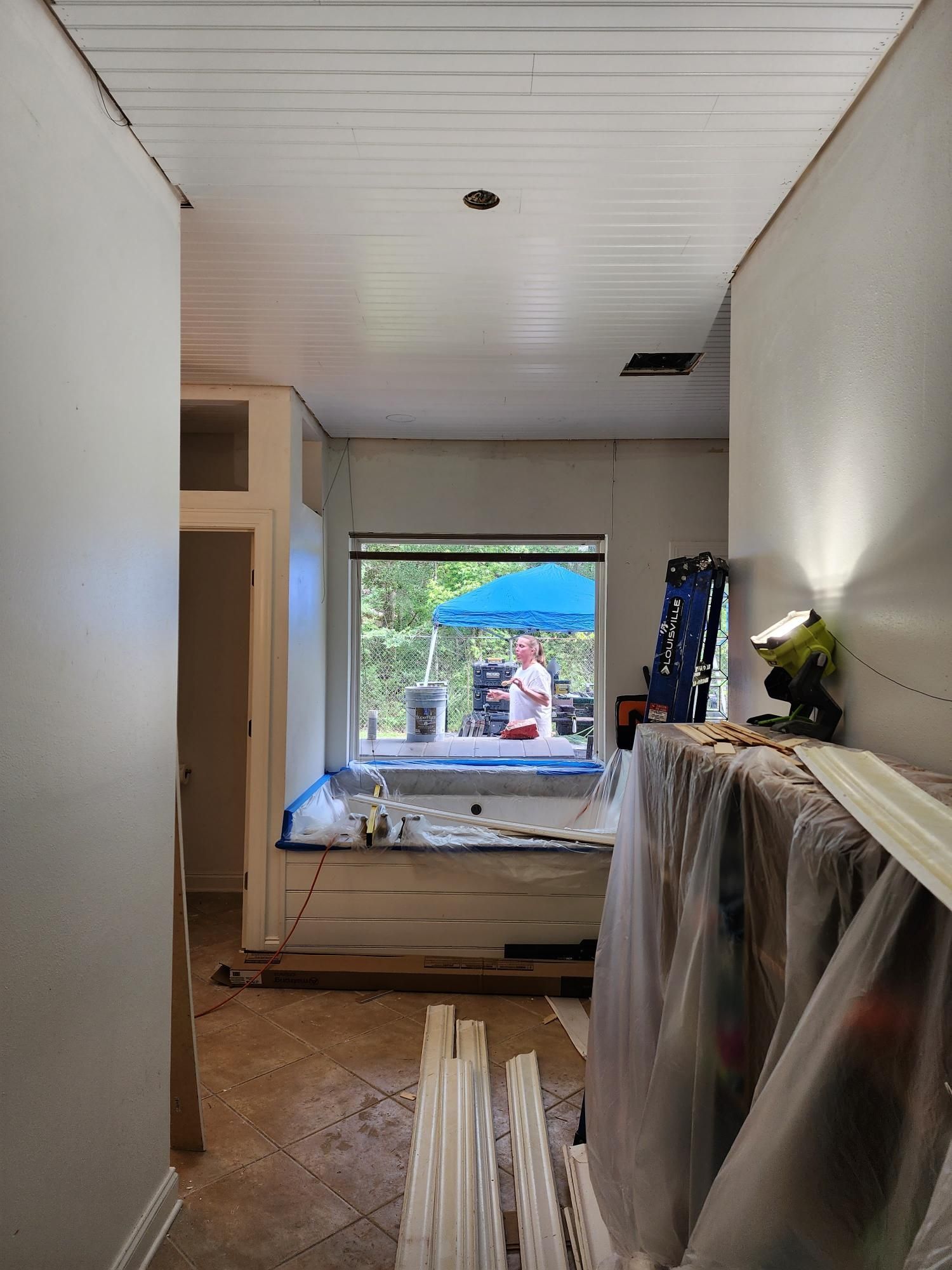 A room with a window and a ceiling that is being remodeled.