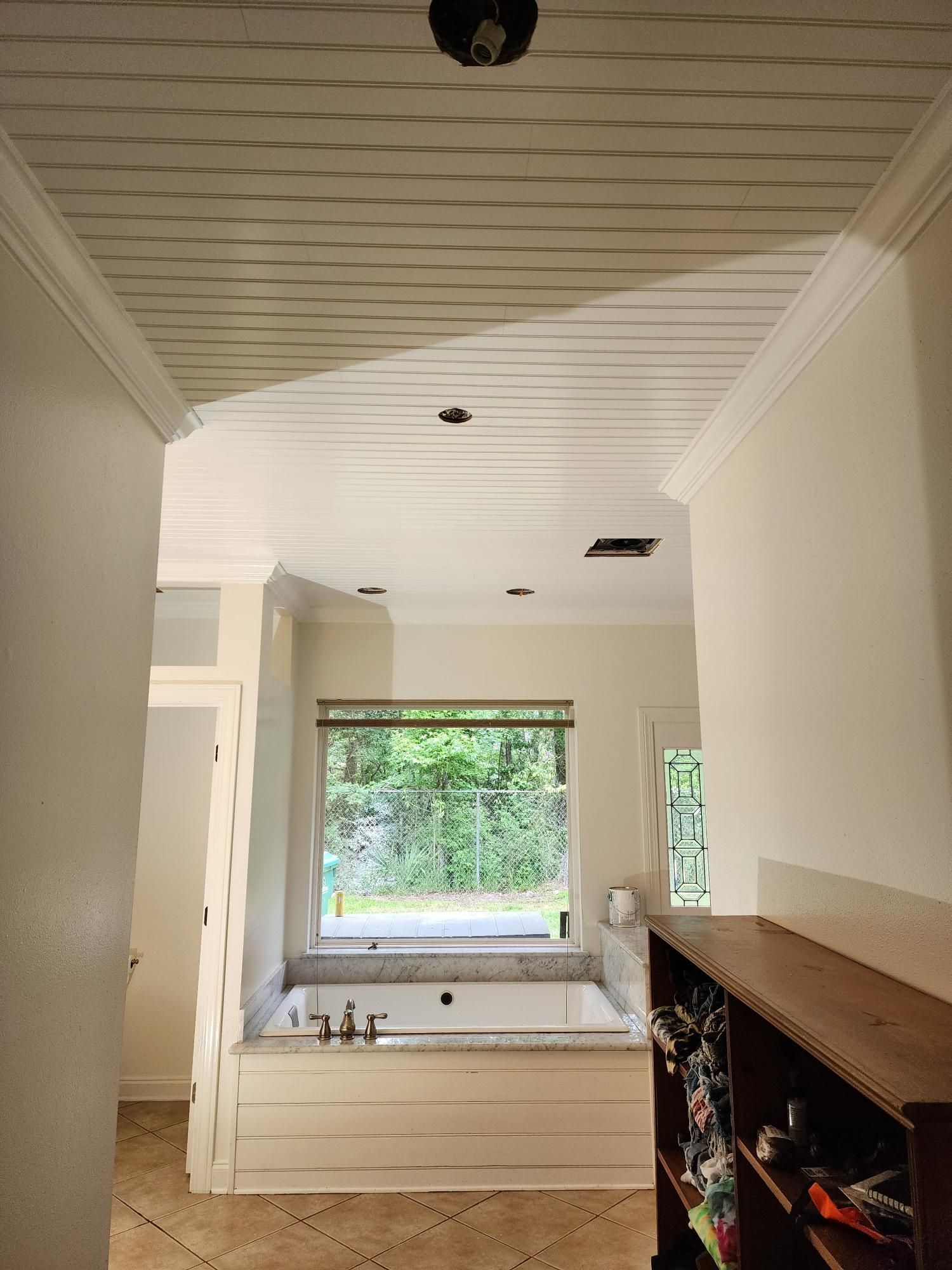 A bathroom with a jacuzzi tub and a window