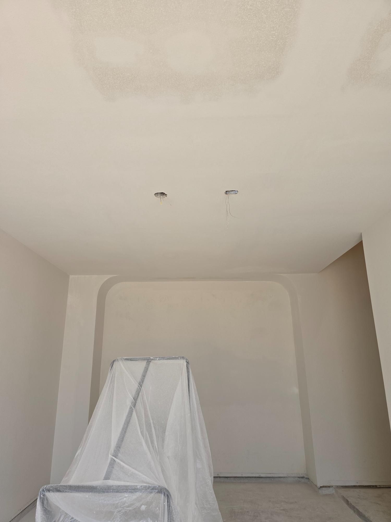 A room with white walls and a ladder in it.