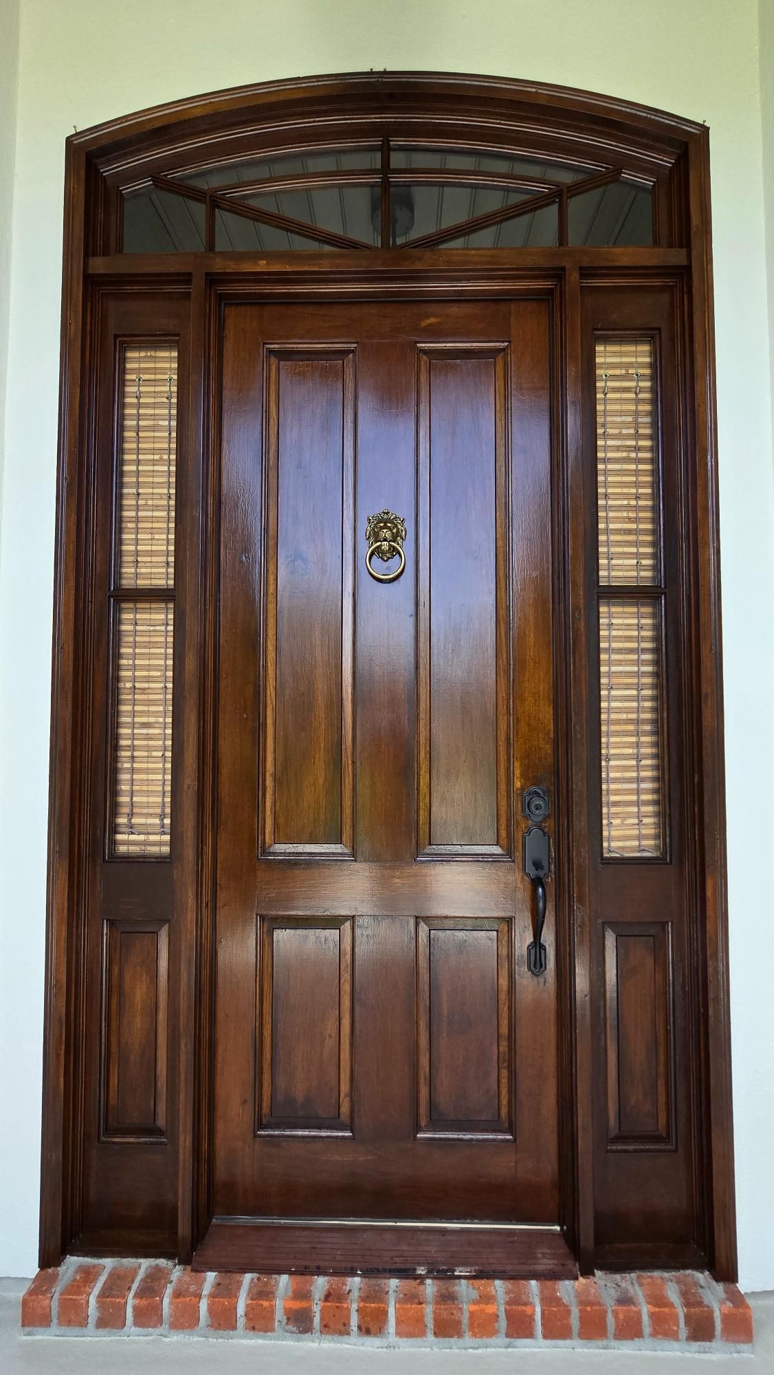 A large wooden door with a door knocker on it