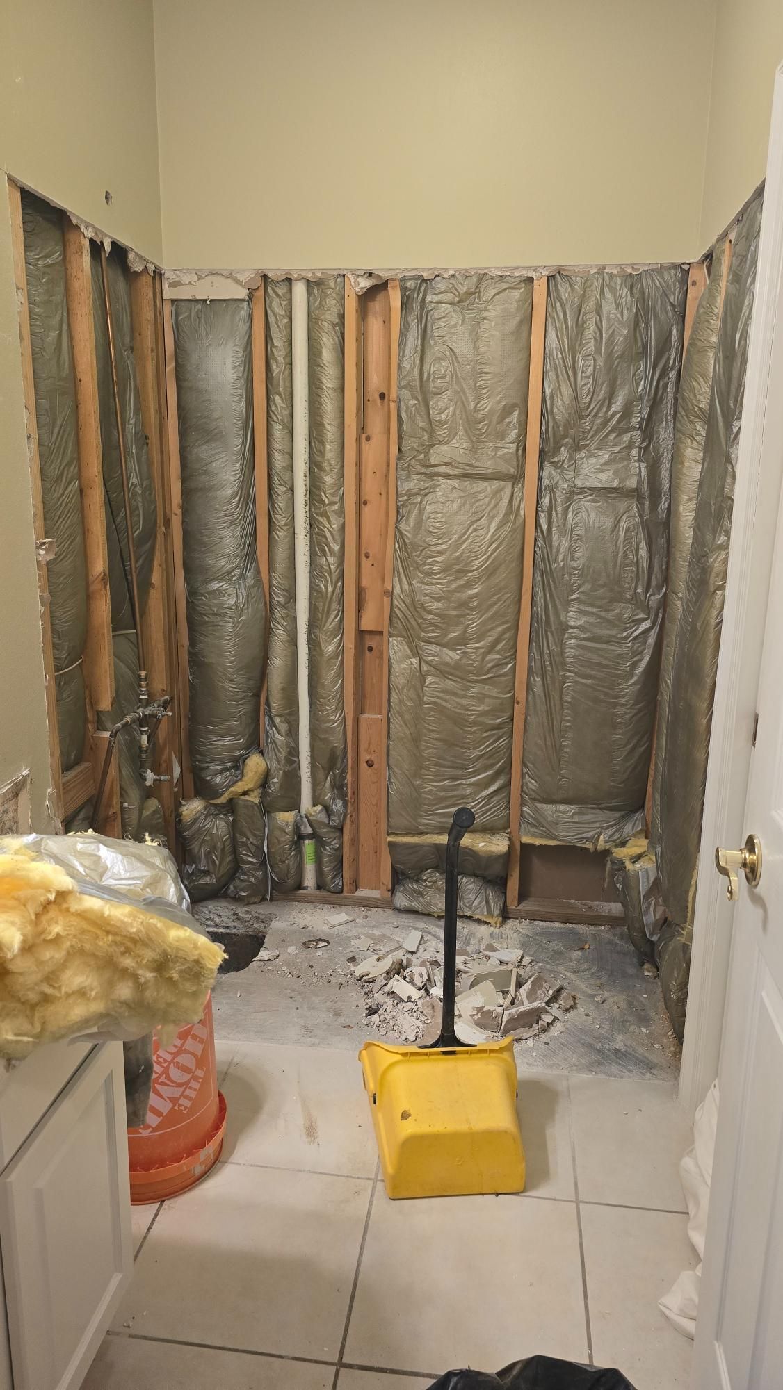 A bathroom is being remodeled with a lot of insulation on the walls.