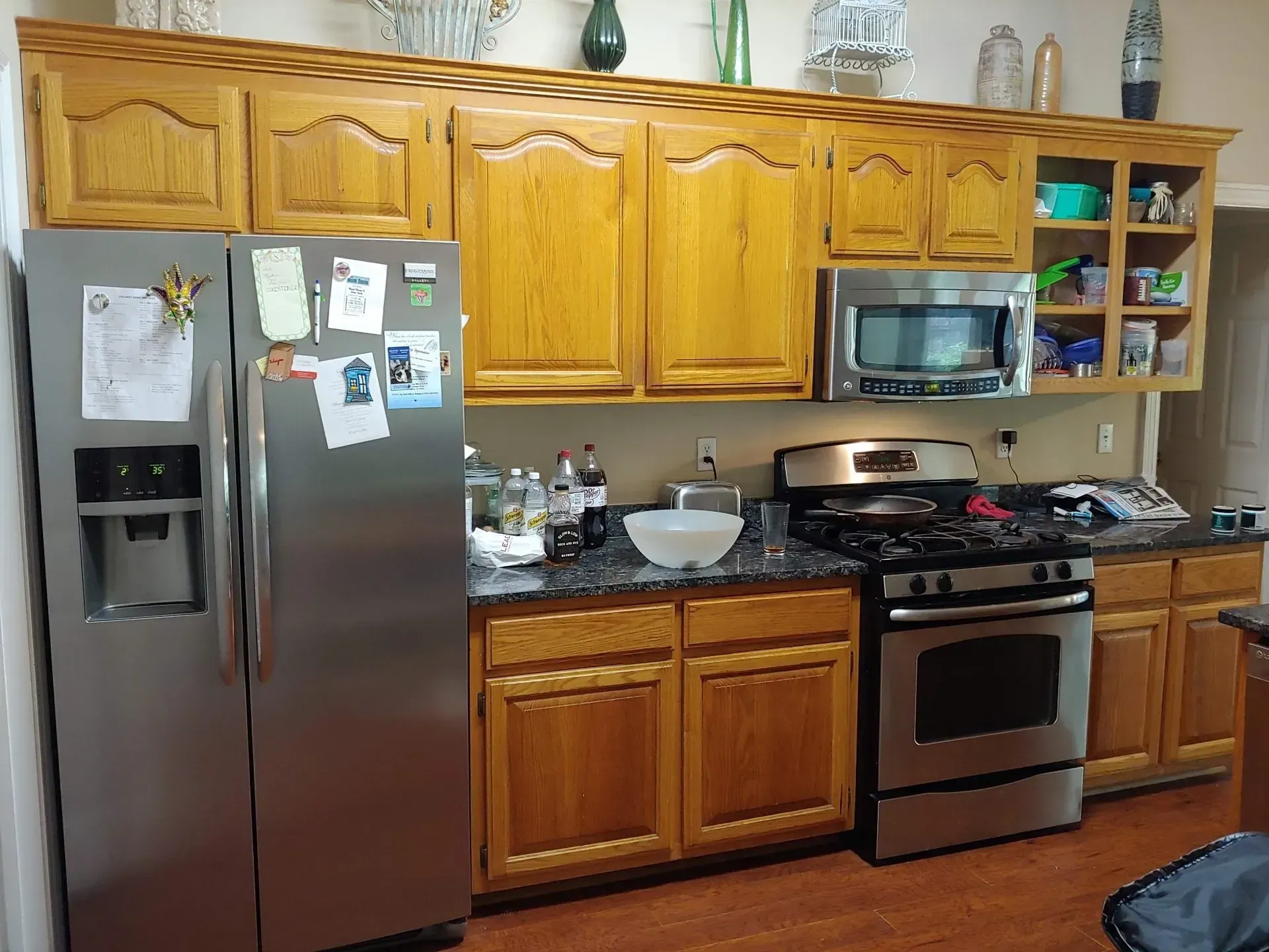A kitchen with stainless steel appliances and wooden cabinets