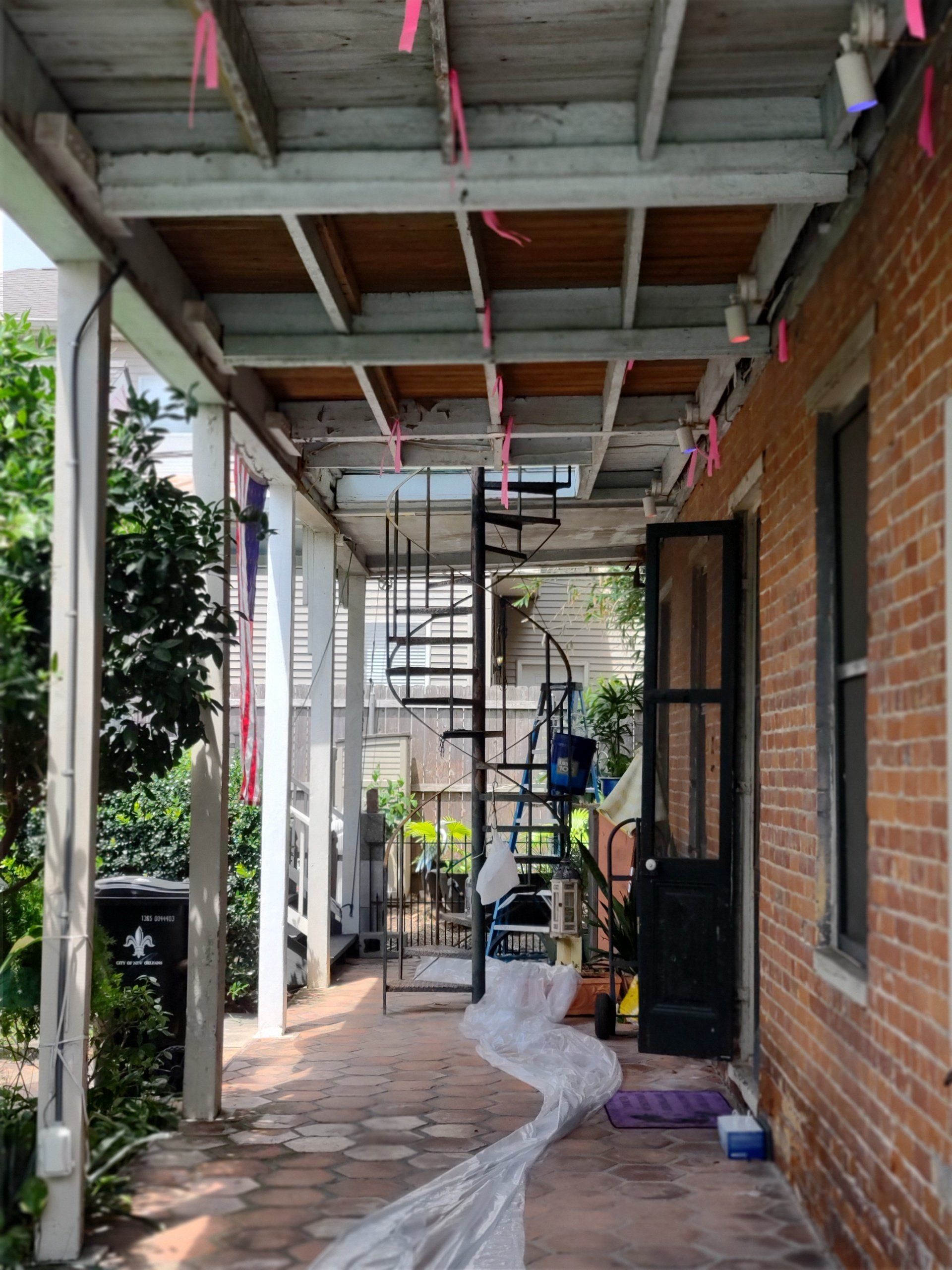 A brick building with a spiral staircase on the side of it