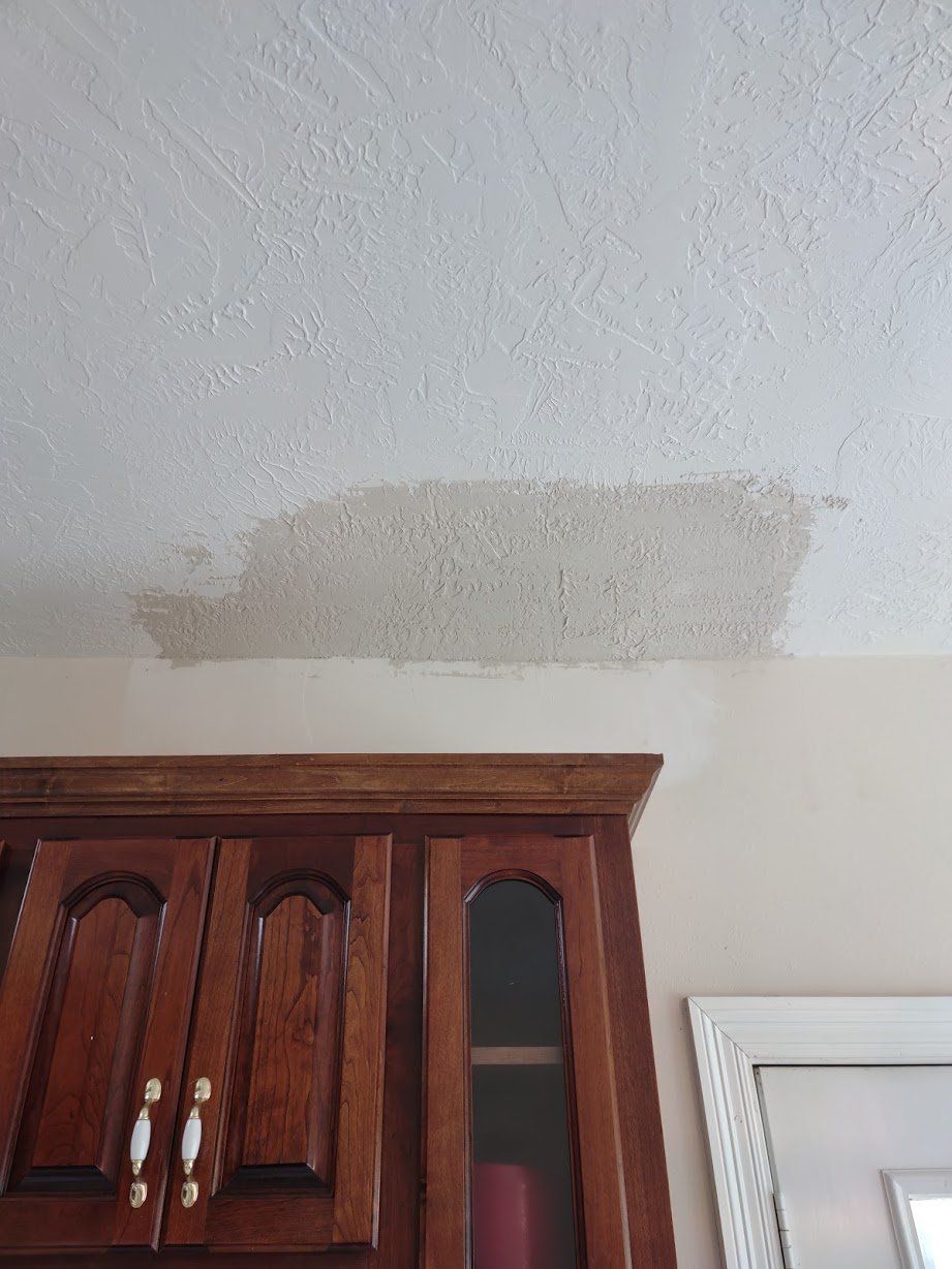 There is a stain on the ceiling above the cabinets.