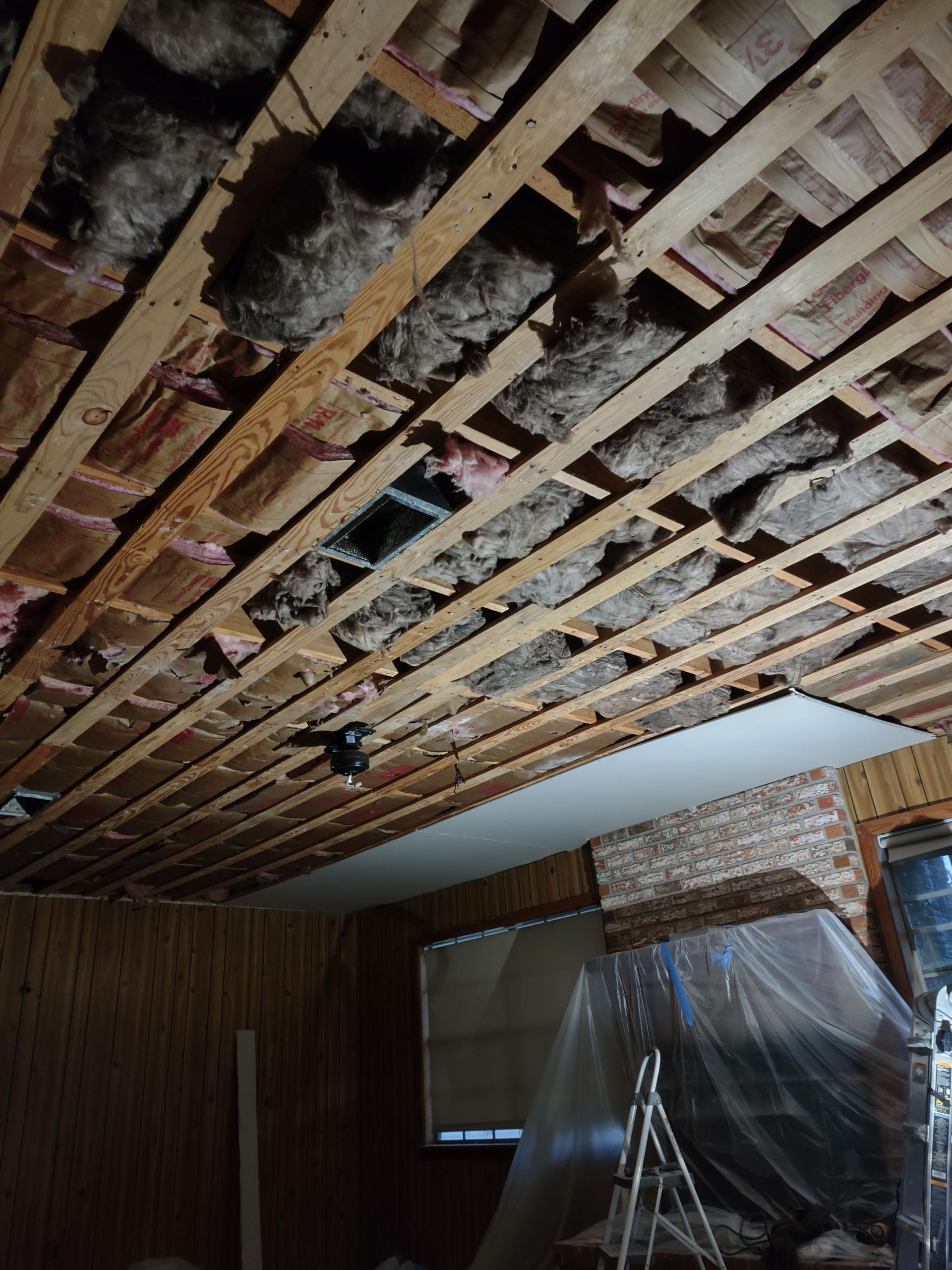 A wooden ceiling with a lot of insulation on it