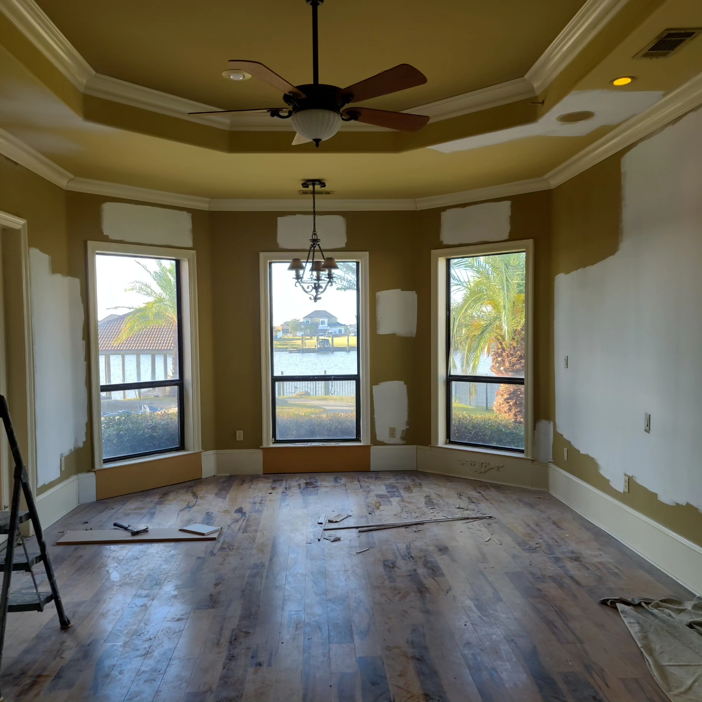 A room with hardwood floors and a ceiling fan