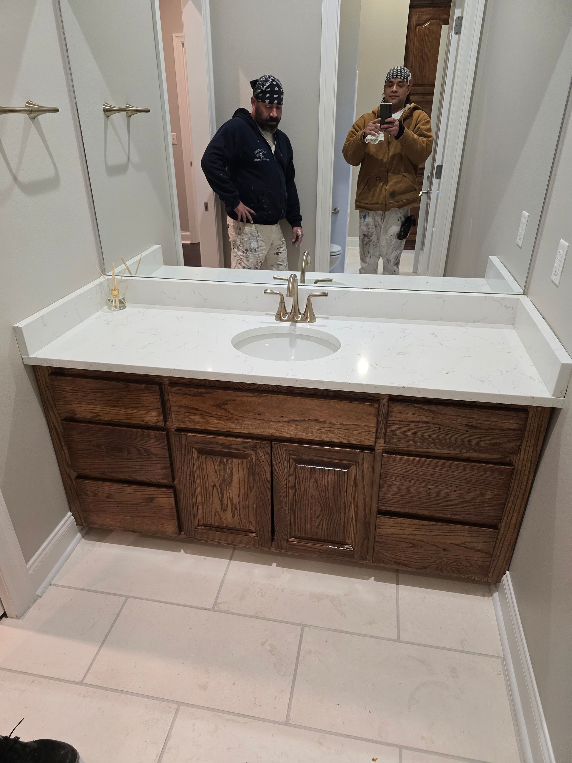 A man is taking a picture of himself in a bathroom mirror.