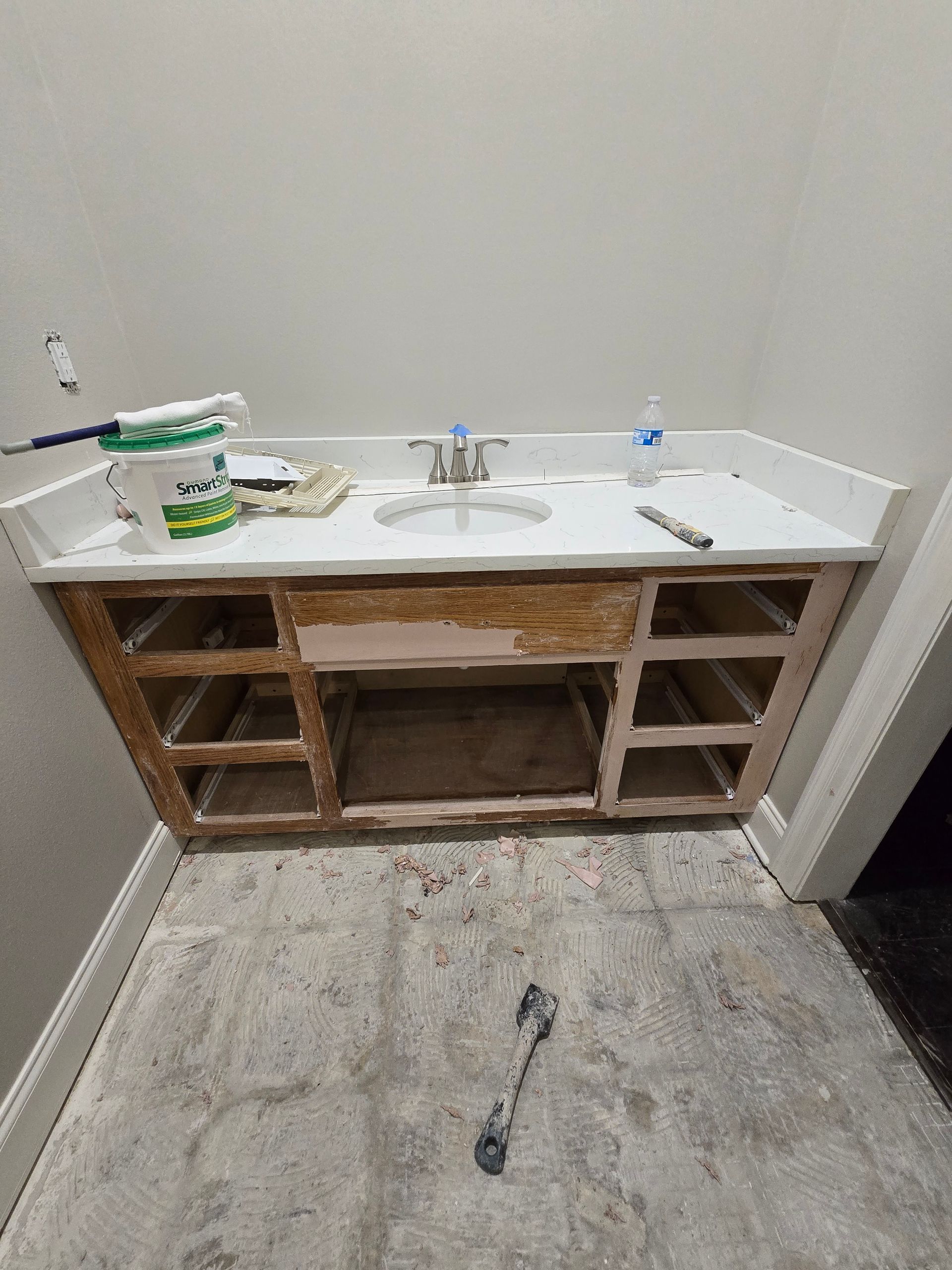 A bathroom vanity is being built in a bathroom.
