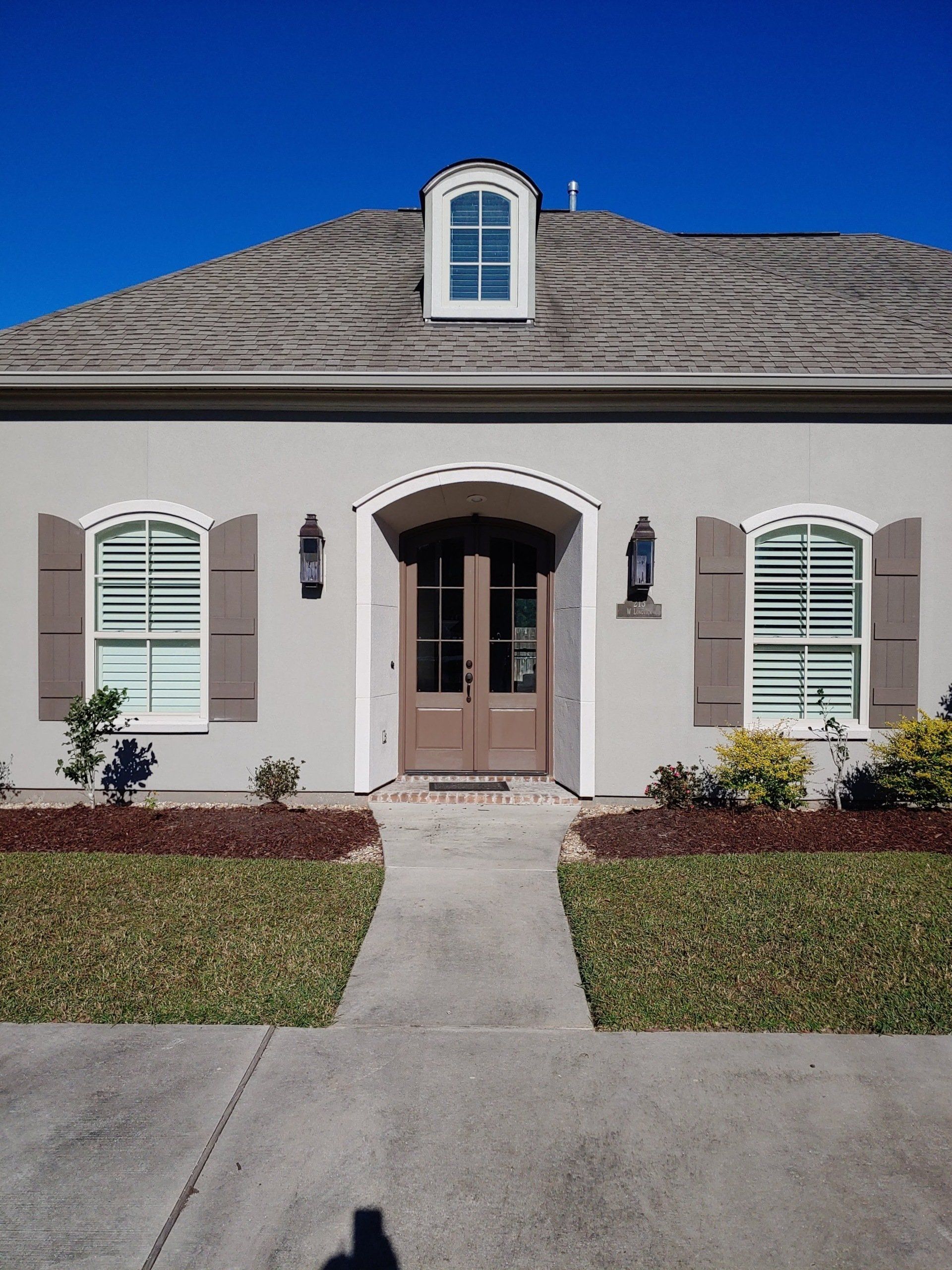 The front of a house with shutters on the windows