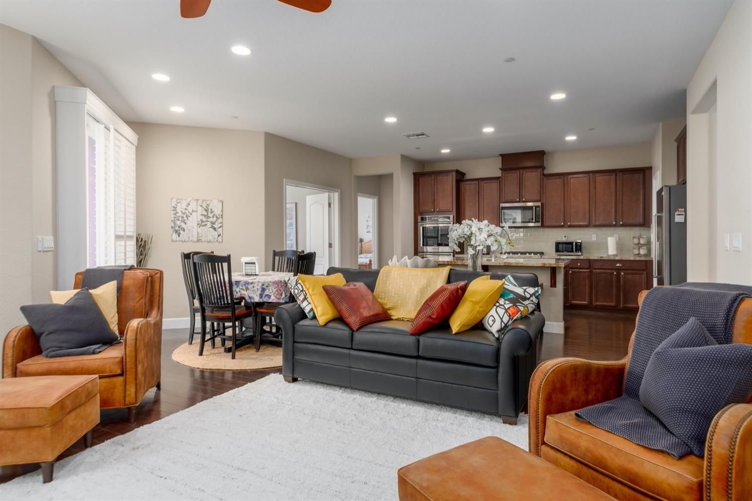 A living room filled with furniture and a ceiling fan.