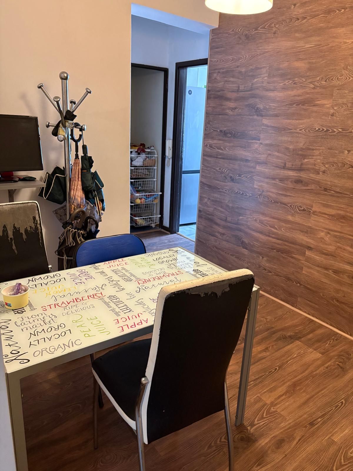 A table and chairs in a room with a wooden wall