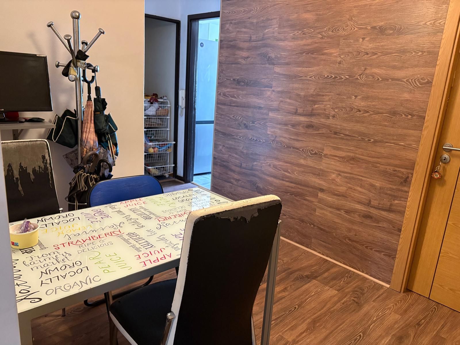 A room with a table and chairs and a wooden wall