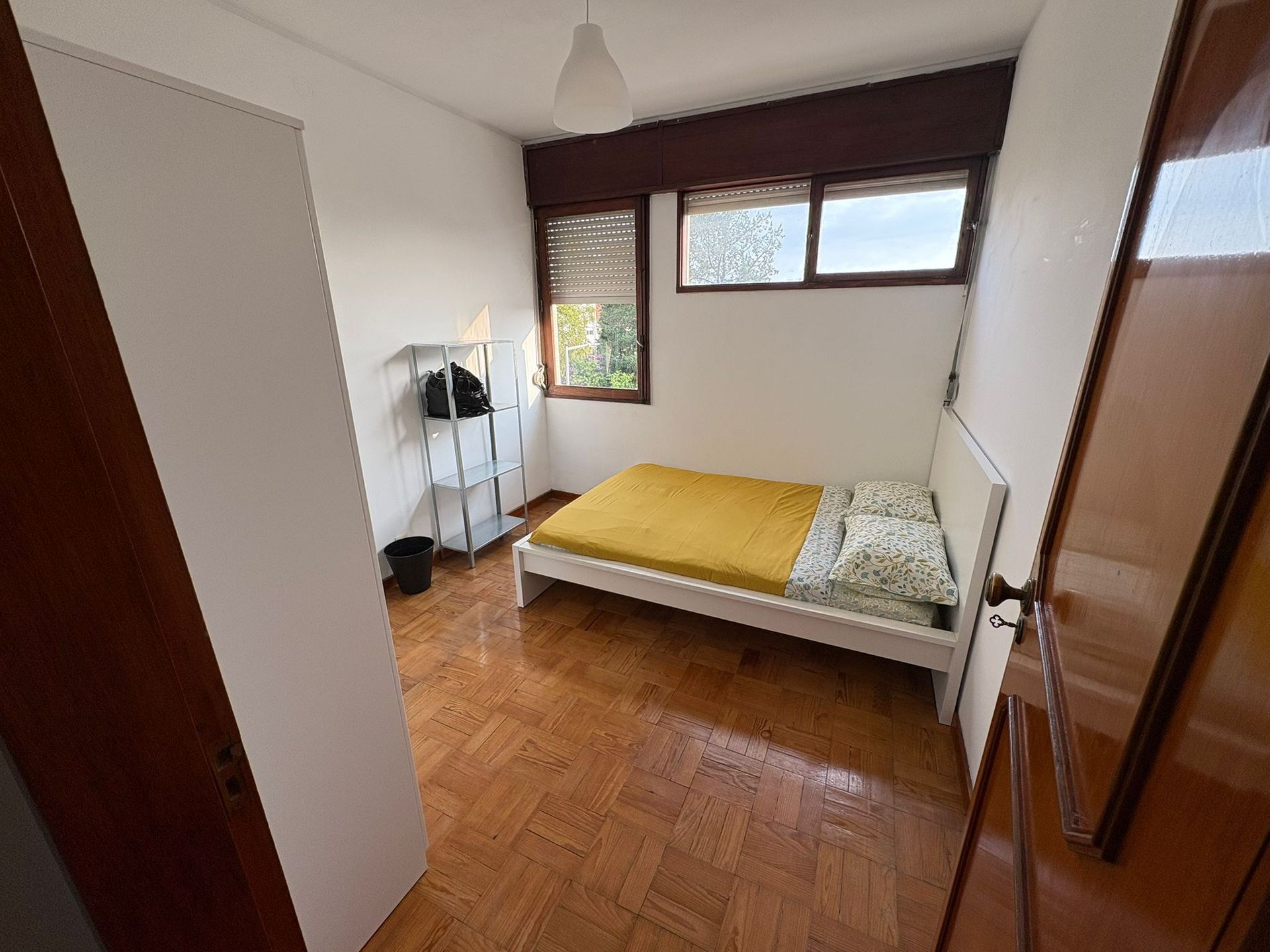 A bedroom with a bed and a sliding glass door