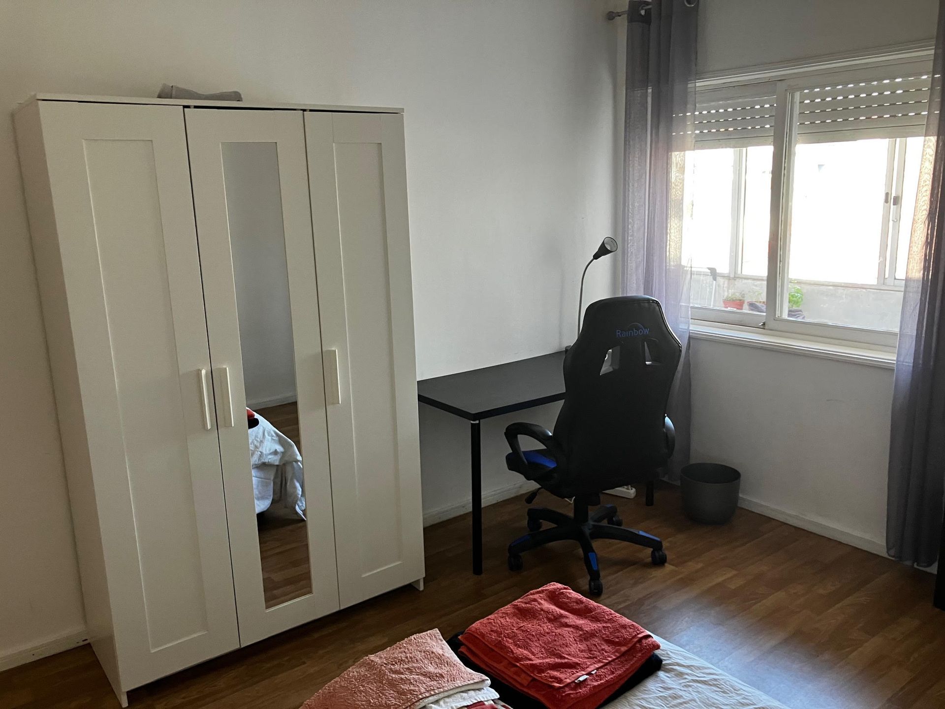 A room with a desk and a chair in it