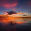 A blurry picture of a sunset over a body of water.