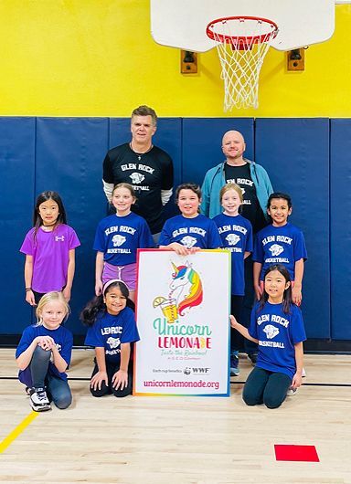 A group of children holding a sign that says unicorn lemonade