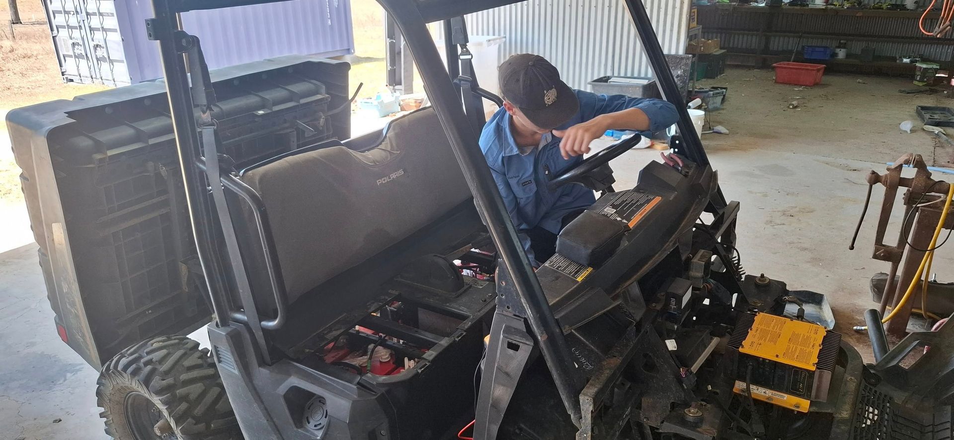 Person in Blue Shirt Works on the Steering Wheel — Buggies & Batteries in Hidden Valley, QLD