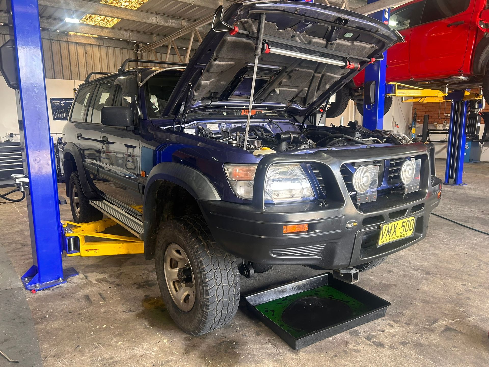 4x4 with open hood getting services