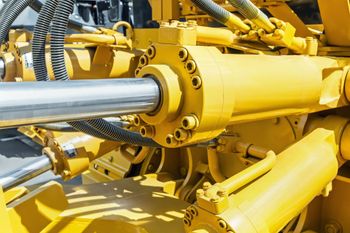 A hydraulic cylinder on a machine.