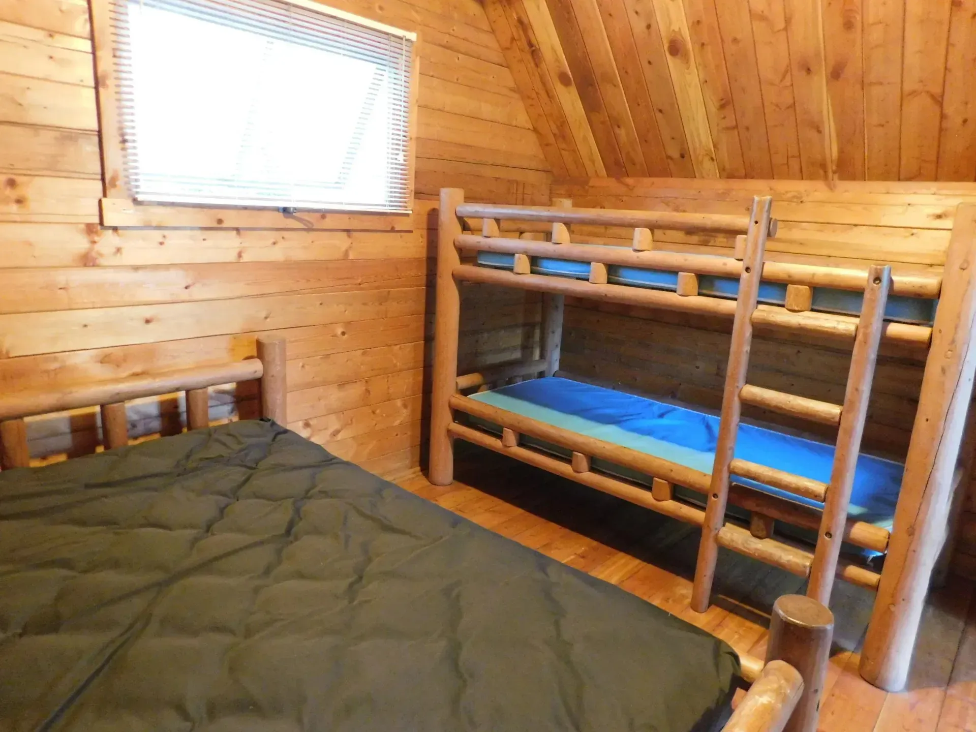 A bedroom with two bunk beds and a bed