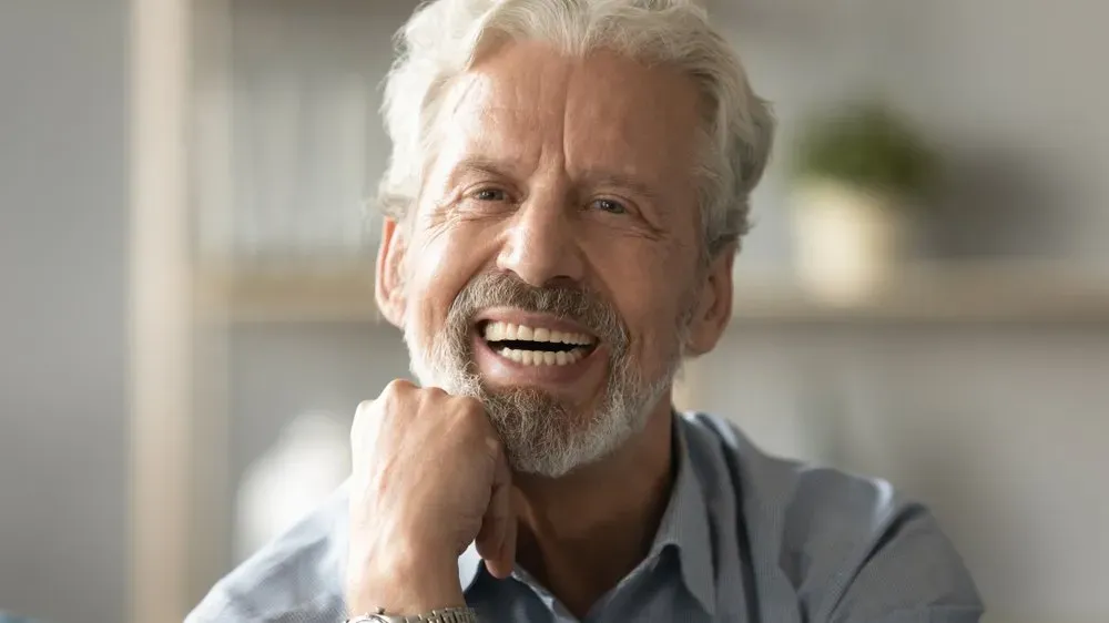 Happy Old Man Smiling Showing Dentures — The Denture Care Group Sunshine Coast in Caloundra, QLD