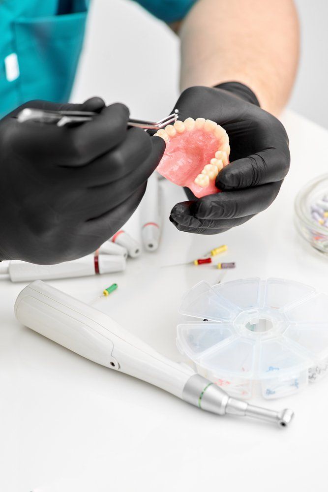 Close Up Of The Dentist's Hands Prosthesis — The Denture Care Group Sunshine Coast in Caloundra, QLD