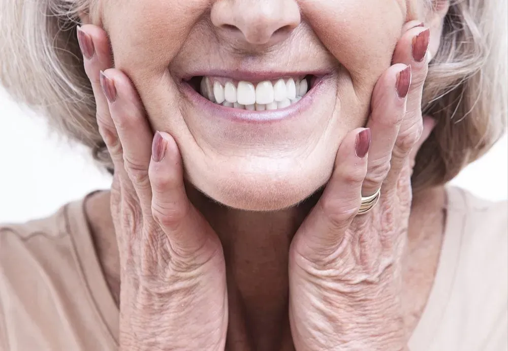 Happy Old Woman Smiling Showing Clean Dentures — The Denture Care Group Sunshine Coast in Caloundra