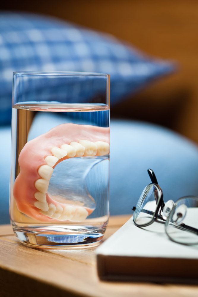 Dentures In A Glass On Bedside — The Denture Care Group Sunshine Coast in Caloundra, QLD