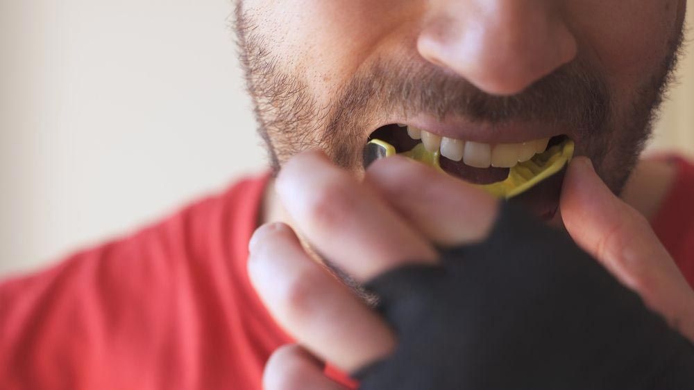 Man Fitting A Mouthguard — The Denture Care Group Sunshine Coast in Caloundra, QLD