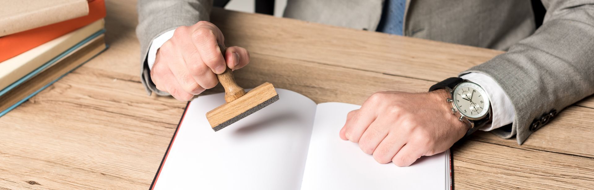 Business professional stamping an official document at a desk