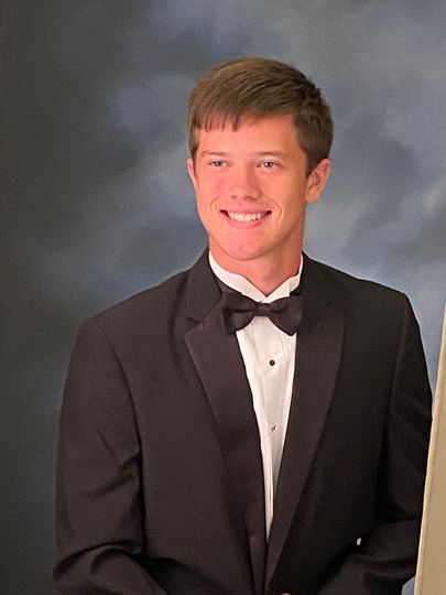 Gray silhouette of a person in a suit and tie on a white background