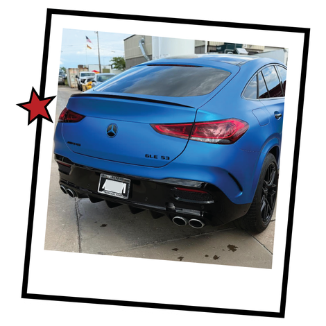 Blue Volkswagen SUV parked outdoors, rear view, with a tilted photo-frame border.