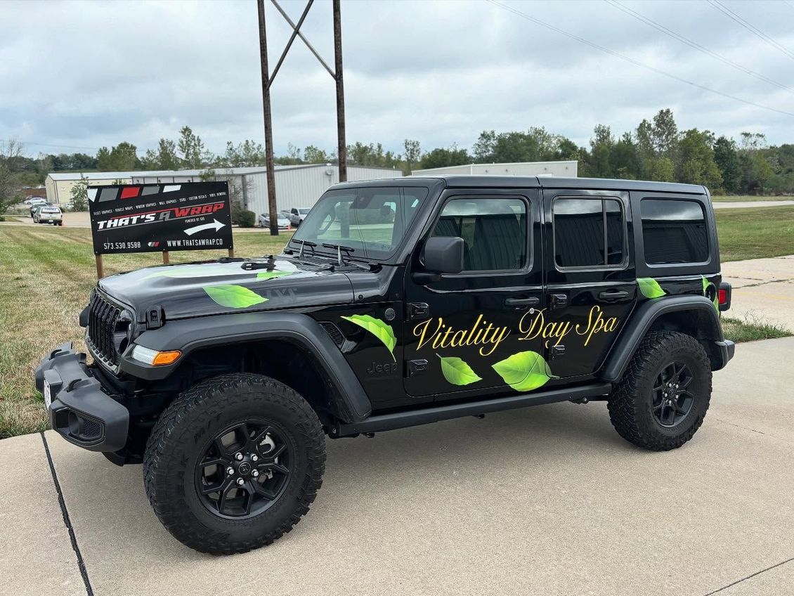 Black Jeep Wrangler with green accents and “Friday Daze” lettering parked outdoors on a road side.
