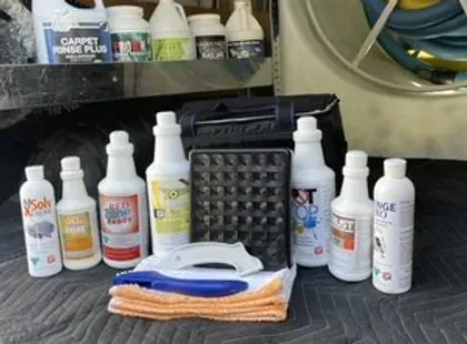 A bunch of bottles of cleaning supplies are sitting on a table