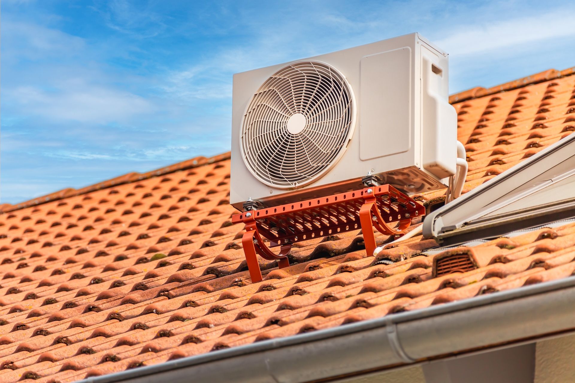 Outdoor Panasonic air conditioning unit mounted on a light-colored wall —FrostyCo Air-Conditioning in Cannonvale, QLD