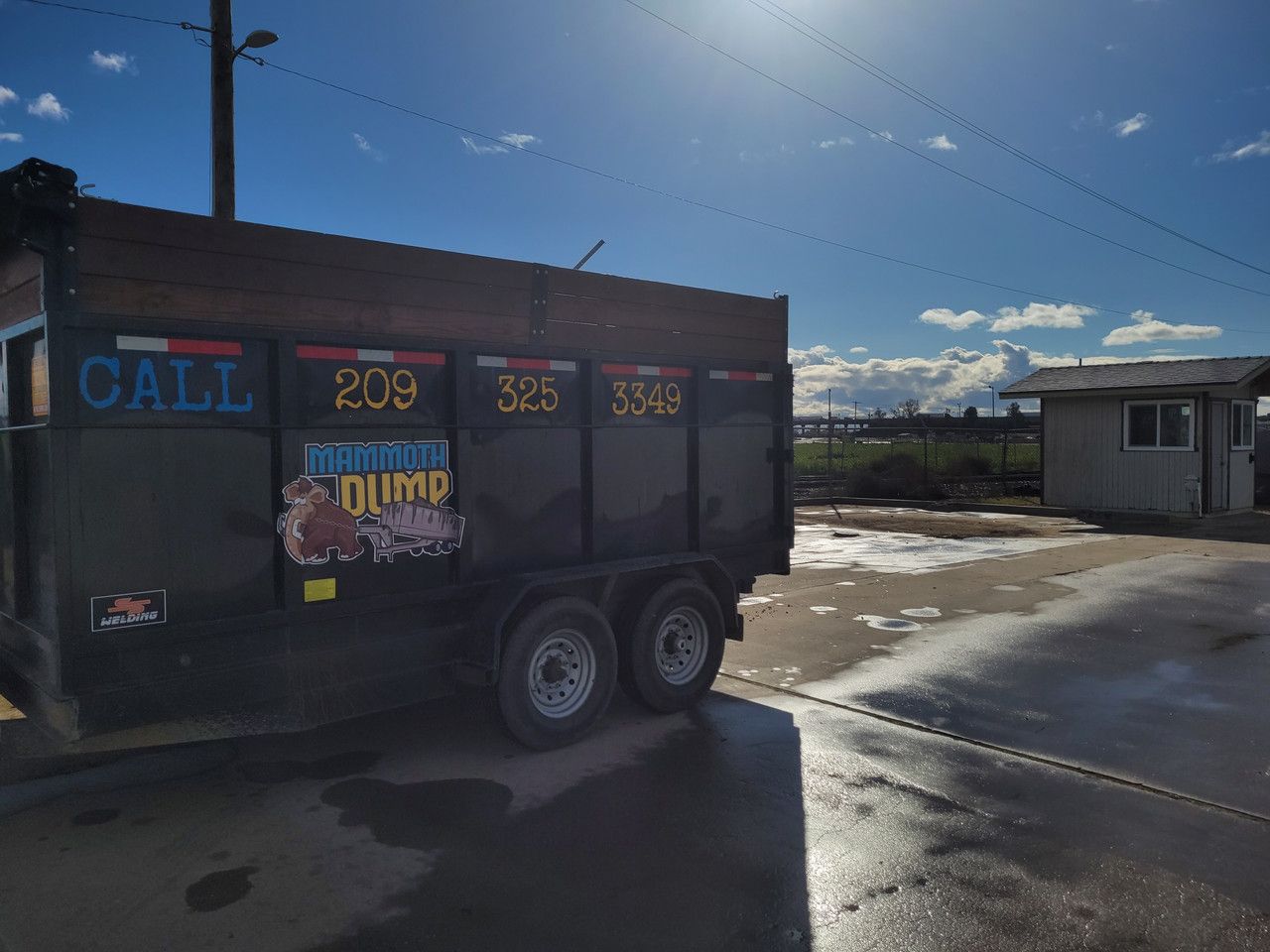 A dumpster is parked on the side of the road.