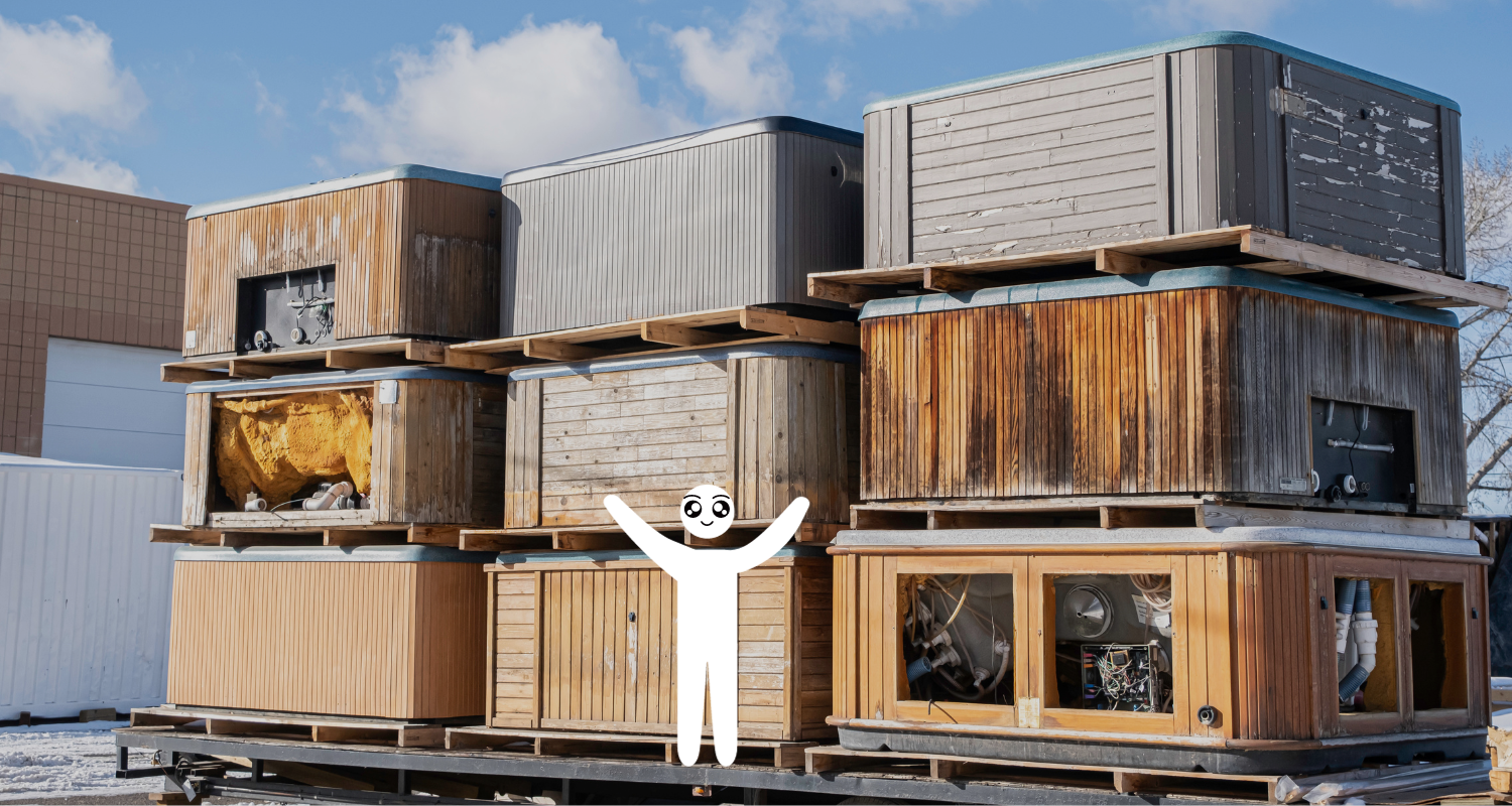A man is standing in front of a stack of wooden boxes.