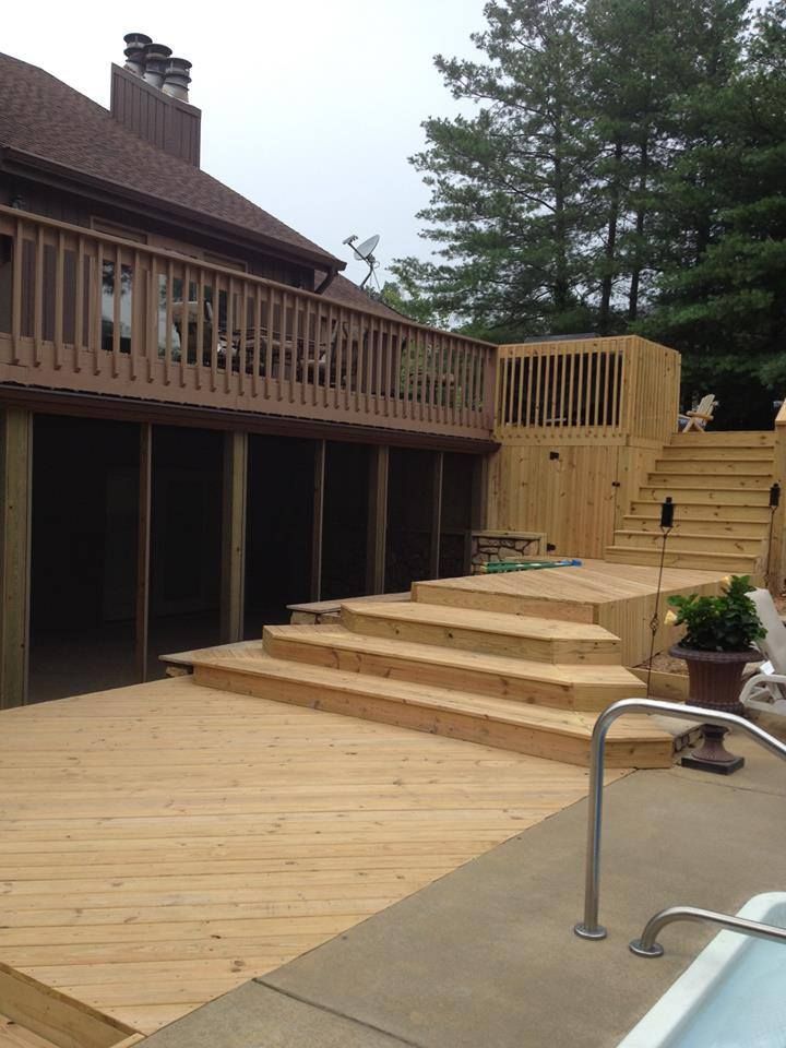 A large wooden deck with stairs leading up to it