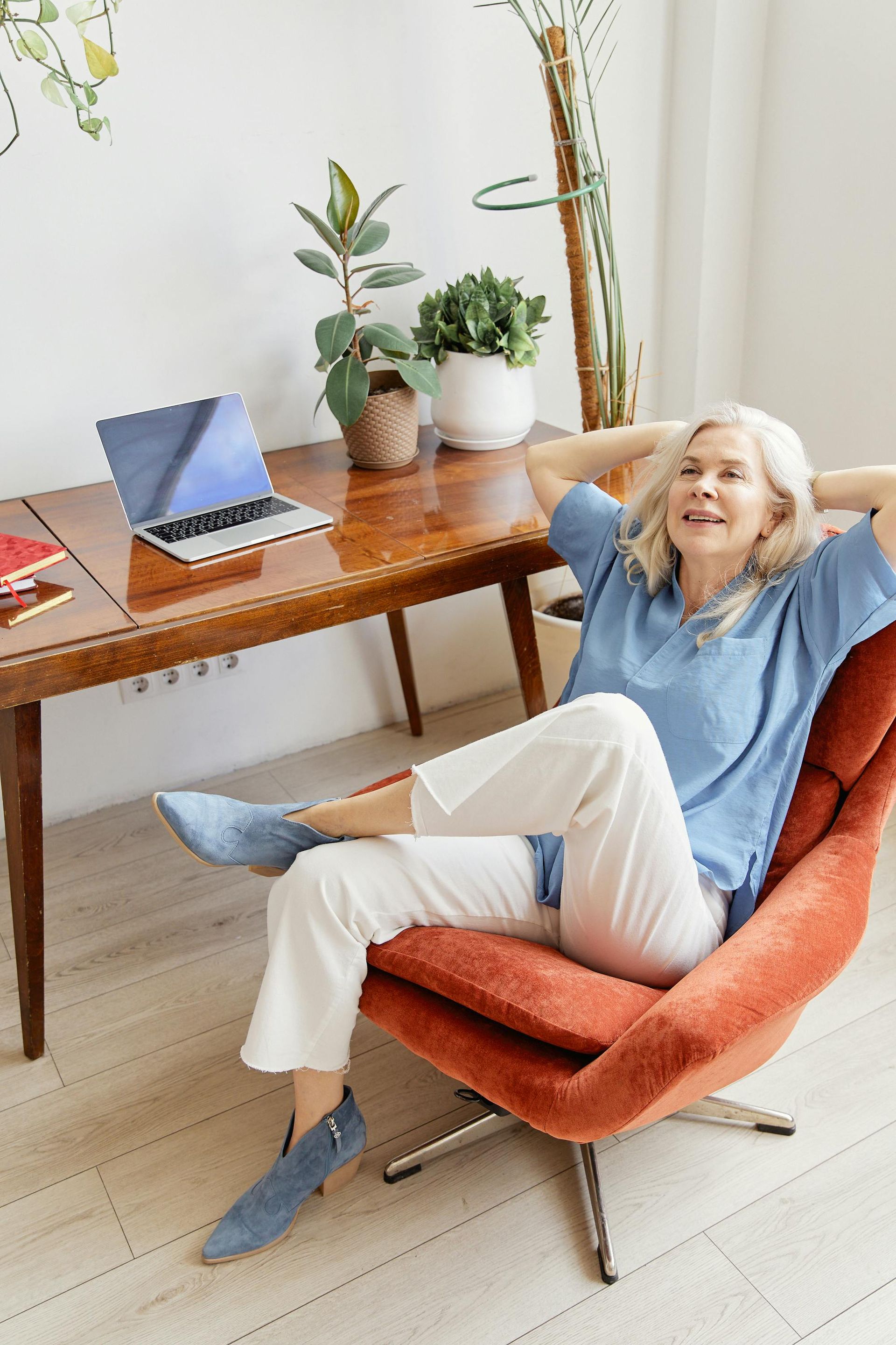 Woman Relaxing in a Chair With Hands Behind Head — Spinal Decompression Sunshine Coast In Maroochydore, QLD