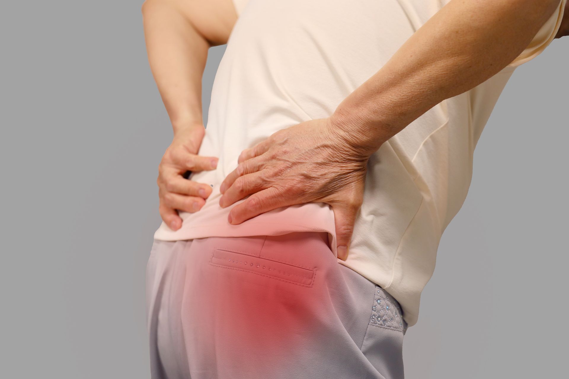Person Holding Their Lower Back, Indicating Pain — Spinal Decompression Sunshine Coast In Mooloolaba, QLD