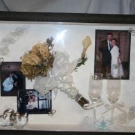Wedding display with flowers, framed photos, and champagne glasses on a white tray