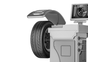 Tire balanced on a machine, with a monitor displaying readings, in a shop setting. | Big n' Littles Auto Body
