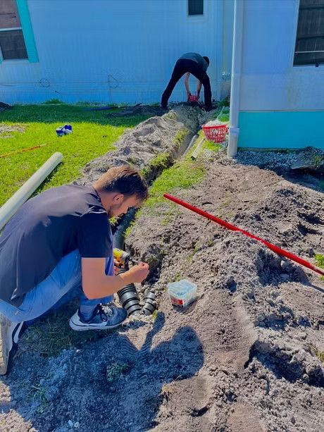 A man working to install a water drainage
