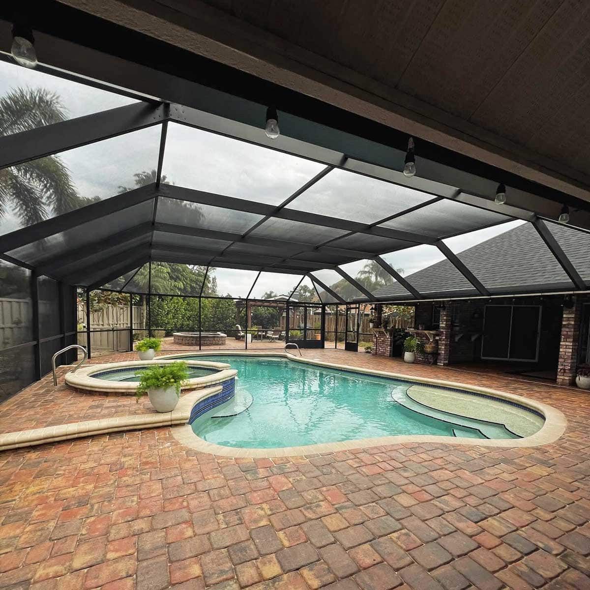 A large swimming pool in the backyard of a house.