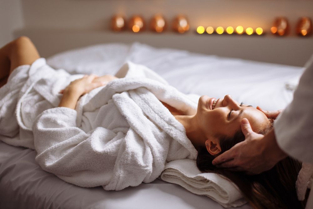Woman Receiving a Facial Massage, Relaxed on A Bed — Beauty In Profile In Salamander Bay, NSW