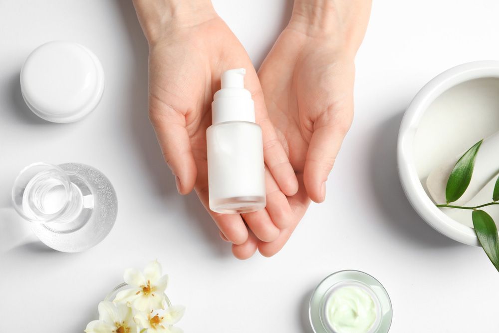 Hands Cradling a Skincare Product Bottle — Beauty In Profile In Salamander Bay, NSW