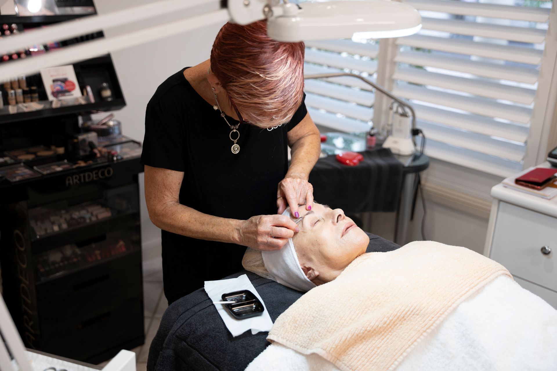 A Woman Receiving a Facial Treatment in A Spa — Beauty In Profile In Salamander Bay, NSW