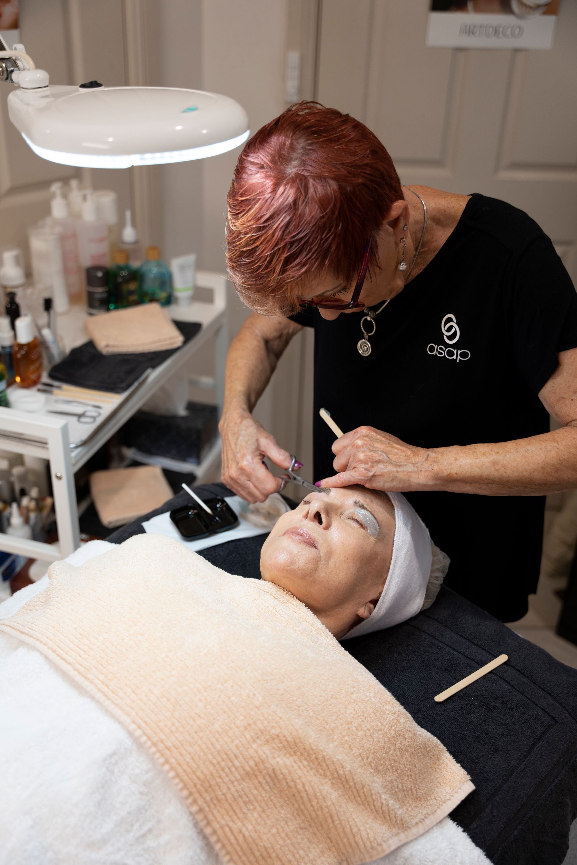 Woman Receiving Eyebrow Treatment in A Salon — Beauty In Profile In Salamander Bay, NSW